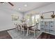 Formal dining room with seating for eight and a large shuttered window at 1342 E Jade Dr, Chandler, AZ 85286