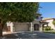 Charming home featuring a two-car garage, covered entry, and a well-maintained front yard with mature tree at 1342 E Jade Dr, Chandler, AZ 85286