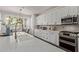 Bright kitchen featuring an island, white cabinets, stainless steel appliances and eat-in kitchen at 1342 E Jade Dr, Chandler, AZ 85286