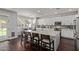 Bright kitchen featuring a spacious island, white cabinets, and dark hardwood floors at 1342 E Jade Dr, Chandler, AZ 85286