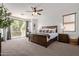 Spacious main bedroom with balcony access, large windows, and a plush king-size bed at 1342 E Jade Dr, Chandler, AZ 85286