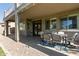 Covered patio with table set on stone bed, perfect for outdoor entertaining at 1342 E Jade Dr, Chandler, AZ 85286