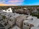 Aerial view of residential homes on the water with well manicured landscaping and mountain views at 1414 W Coral Reef Dr, Gilbert, AZ 85233