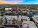 Aerial view of residential homes on the water featuring mountain views in the distance at 1414 W Coral Reef Dr, Gilbert, AZ 85233