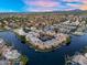 High angle aerial view of the tops of waterfront property featuring neighborhood pool and gorgeous landscaping at 1414 W Coral Reef Dr, Gilbert, AZ 85233