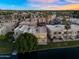 Aerial view of the back of a house located on the water with palm trees, green space, and privacy at 1414 W Coral Reef Dr, Gilbert, AZ 85233