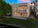 Charming backyard featuring a cozy patio, grassy area, and waterfront views of the canal at 1414 W Coral Reef Dr, Gilbert, AZ 85233