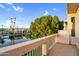 A beautiful waterfront view from the balcony with a large, leafy green tree between balcony and neighboring house at 1414 W Coral Reef Dr, Gilbert, AZ 85233