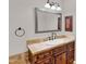 Vanity featuring granite countertops, framed mirror, and bronze fixtures at 1414 W Coral Reef Dr, Gilbert, AZ 85233