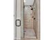 Modern tiled shower room with a glass door and bronze shower fixture at 1414 W Coral Reef Dr, Gilbert, AZ 85233