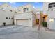 Inviting condo exterior with a garage, well-manicured landscaping, and charming architectural details at 1414 W Coral Reef Dr, Gilbert, AZ 85233