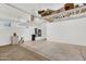 A large, bright garage with storage shelves and access to utilities at 1414 W Coral Reef Dr, Gilbert, AZ 85233