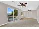A sun-filled living room features a balcony and ceiling fans at 1414 W Coral Reef Dr, Gilbert, AZ 85233
