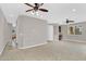 This large living room features carpet flooring, ceiling fans, and natural light at 1414 W Coral Reef Dr, Gilbert, AZ 85233
