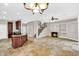 Open-concept layout connects the kitchen and living room with a fireplace and staircase at 1414 W Coral Reef Dr, Gilbert, AZ 85233