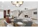 Open-concept living space with a dining area, kitchen island, fireplace, and staircase at 1414 W Coral Reef Dr, Gilbert, AZ 85233