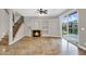 Spacious living room features a staircase, fireplace, built-in shelves, and patio access at 1414 W Coral Reef Dr, Gilbert, AZ 85233