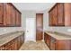 A spacious pantry has beautiful wood cabinets and granite countertops at 1414 W Coral Reef Dr, Gilbert, AZ 85233