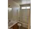 Well-lit bathroom with a shower and tub combination, a single sink vanity, and a window at 15088 N 85Th Dr, Peoria, AZ 85381