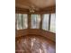 Bright living room featuring multiple windows, light-colored walls, and laminate flooring at 15088 N 85Th Dr, Peoria, AZ 85381