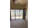 The main bedroom featuring a sliding glass door to the backyard and neutral decor at 15088 N 85Th Dr, Peoria, AZ 85381