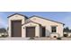 Beautiful single-Gathering home featuring a two-car garage, neutral stucco, and a covered front entryway at 15727 W Brown St, Waddell, AZ 85355
