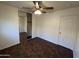 Bedroom featuring tiled floors, ample lighting, mirrored closet doors and a ceiling fan at 15731 W Evans Dr, Surprise, AZ 85379