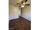 Bedroom with mirrored closet, ceiling fan, and tile flooring at 15731 W Evans Dr, Surprise, AZ 85379