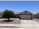 Charming single-story home with a well-maintained front yard and a two-car garage at 15731 W Evans Dr, Surprise, AZ 85379