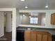 Modern kitchen with a breakfast bar overlooking a spacious living area, creating a warm, inviting space at 15731 W Evans Dr, Surprise, AZ 85379