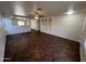 Bright living room with ceiling fan and tile floors, showcasing a cozy built in entertainment center at 15731 W Evans Dr, Surprise, AZ 85379
