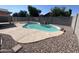 Backyard pool with rock waterfall feature provides a tranquil escape, complete with tanning ledge and privacy wall at 15731 W Evans Dr, Surprise, AZ 85379