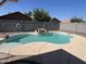 Backyard pool with rock waterfall feature provides a tranquil escape, complete with tanning ledge and privacy wall at 15731 W Evans Dr, Surprise, AZ 85379