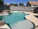 Sparkling blue pool with concrete surround, surrounded by rock landscaping creating an inviting backyard retreat at 15731 W Evans Dr, Surprise, AZ 85379