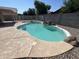 Backyard pool featuring rock waterfall, clear water, and surrounding rock landscape offers a serene escape at 15731 W Evans Dr, Surprise, AZ 85379