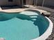 Inviting pool with tanning deck and clear blue water, surrounded by rock accents and a protective fence at 15731 W Evans Dr, Surprise, AZ 85379