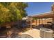 A backyard with a covered patio, lawn, trees and trampoline at 15737 W Lundberg St, Surprise, AZ 85374