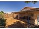 A backyard with a covered patio, lawn and trampoline at 15737 W Lundberg St, Surprise, AZ 85374