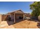 A backyard with a covered patio, lawn and trampoline at 15737 W Lundberg St, Surprise, AZ 85374