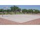 An outdoor basketball court surrounded by trees and landscaping at 15737 W Lundberg St, Surprise, AZ 85374