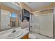 Standard bathroom with a tub/shower combo, a pedestal sink, and decorative mirror at 15737 W Lundberg St, Surprise, AZ 85374