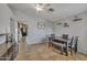 Open dining area with tile flooring, stylish table set, and decor shelving adding charm to the space at 15737 W Lundberg St, Surprise, AZ 85374