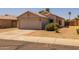 Street-level exterior view of a single-story home with low-maintenance landscaping and a two-car garage at 15737 W Lundberg St, Surprise, AZ 85374
