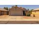Charming single-story home with a neutral color scheme, tile roof, and a two-car garage at 15737 W Lundberg St, Surprise, AZ 85374