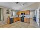 Traditional-style kitchen with tile floors, light wood cabinets, black appliances, and light countertops at 15737 W Lundberg St, Surprise, AZ 85374