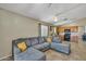 Spacious living area with tile flooring, a comfortable sectional, and a seamless transition to the adjacent kitchen at 15737 W Lundberg St, Surprise, AZ 85374