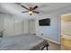 Contemporary bedroom with a modern ceiling fan, wood floor, and sliding closet doors at 15737 W Lundberg St, Surprise, AZ 85374