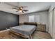 Contemporary bedroom with a modern ceiling fan, wood floor, a paneled accent wall, and contemporary furniture at 15737 W Lundberg St, Surprise, AZ 85374