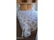 A comfortable bedroom features a bed with a floral quilt, providing a relaxing and inviting atmosphere at 17200 W Bell Rd # 1501, Surprise, AZ 85374