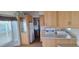 Bright, open kitchen features wooden cabinets, white appliances, ample counter space, and convenient layout at 17200 W Bell Rd # 1501, Surprise, AZ 85374
